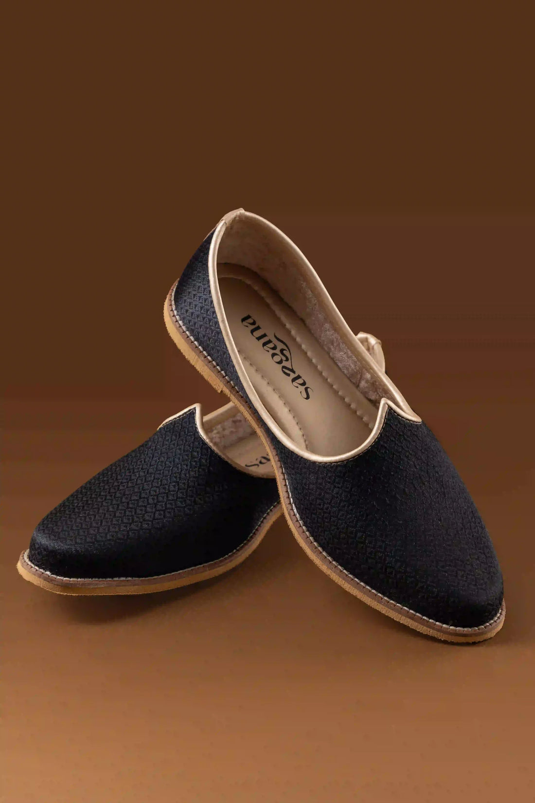 Side perspective of the black jutti highlighting the elegant texture