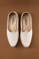 Handcrafted jutti showcasing the back design with off white butta pattern