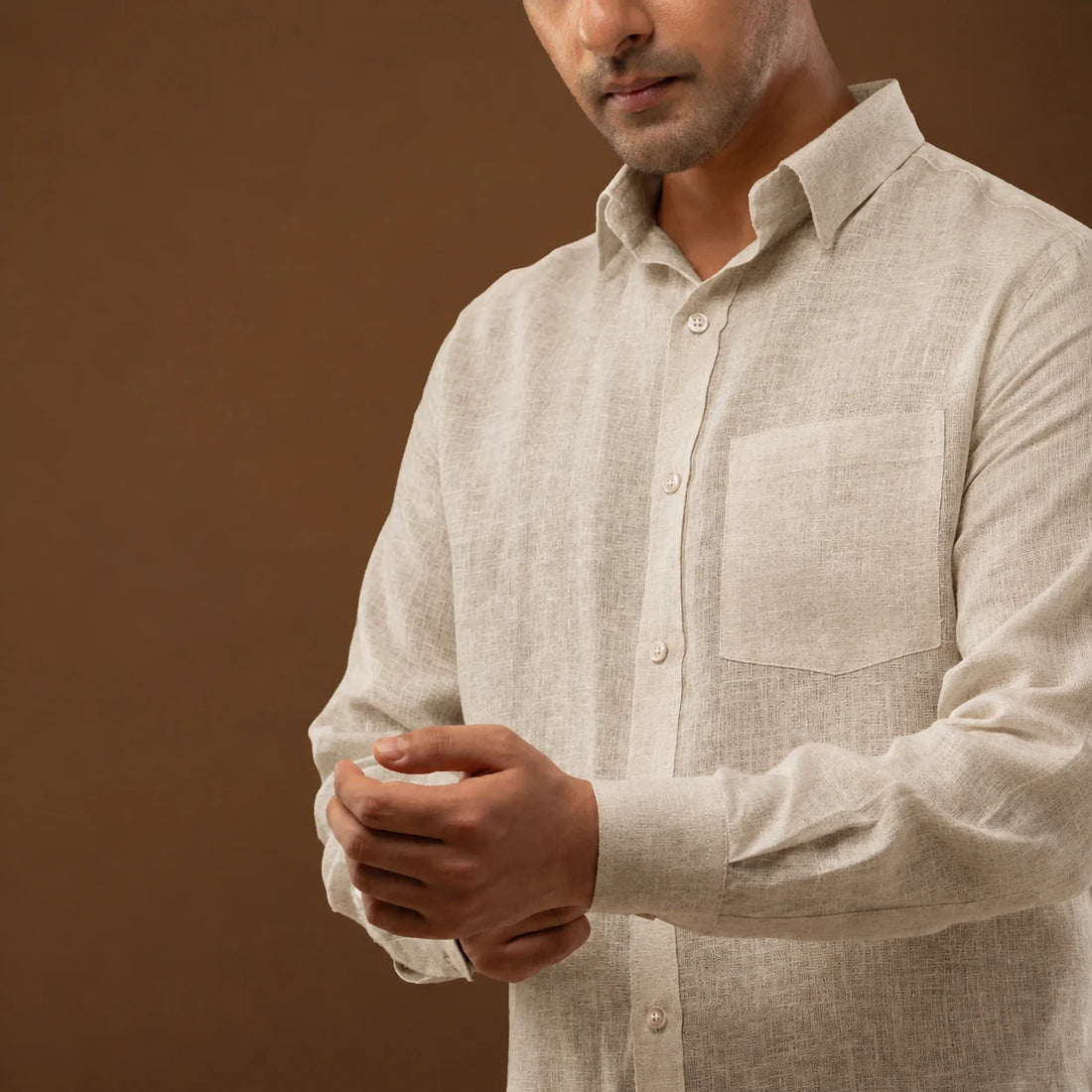 Close-up of wooden button detail on linen shirt