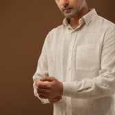 Close-up of wooden button detail on linen shirt