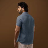 Model wearing Steel Blue 100% Linen Shirt with rolled-up sleeves