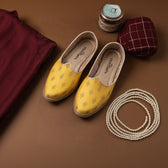 Side view of handcrafted Yellow Butta Printed Jutti with intricate detailing