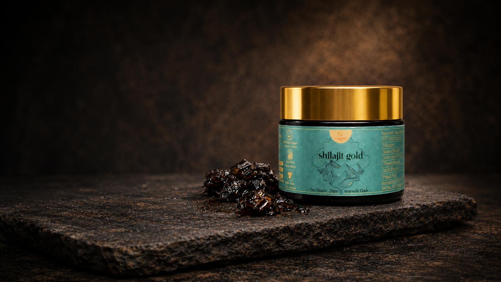 Shilajit Gold jar with raw shilajit resin on stone